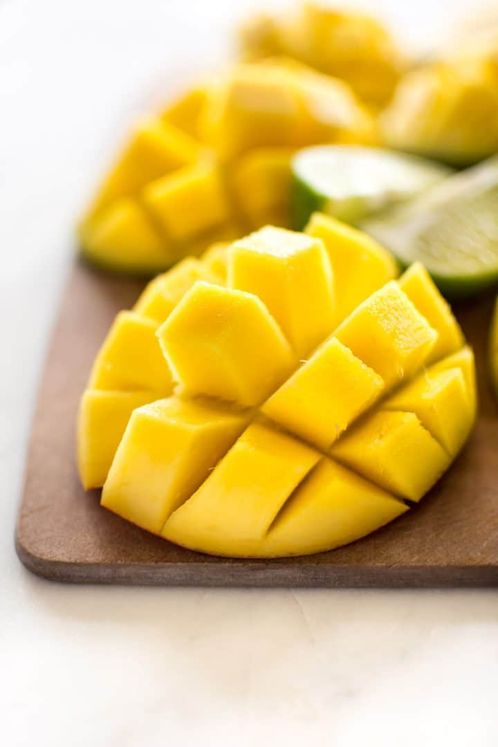 diced mango on a wooden cutting board