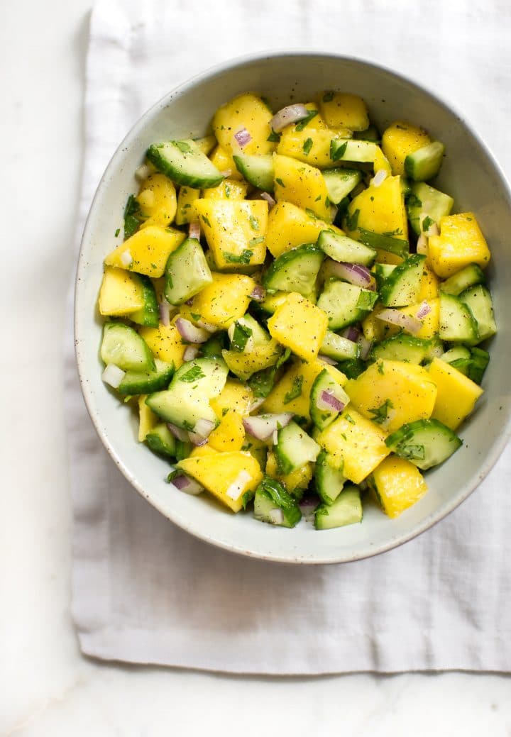 fresh and healthy mango salsa in a small white bowl