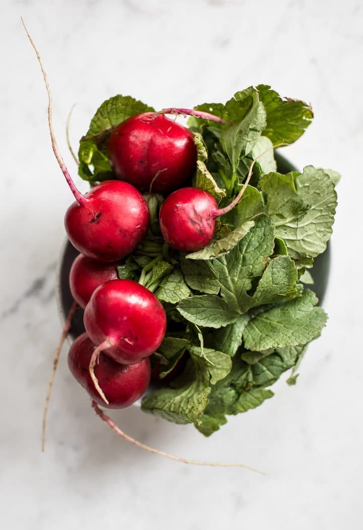 a bunch of radishes with leaves