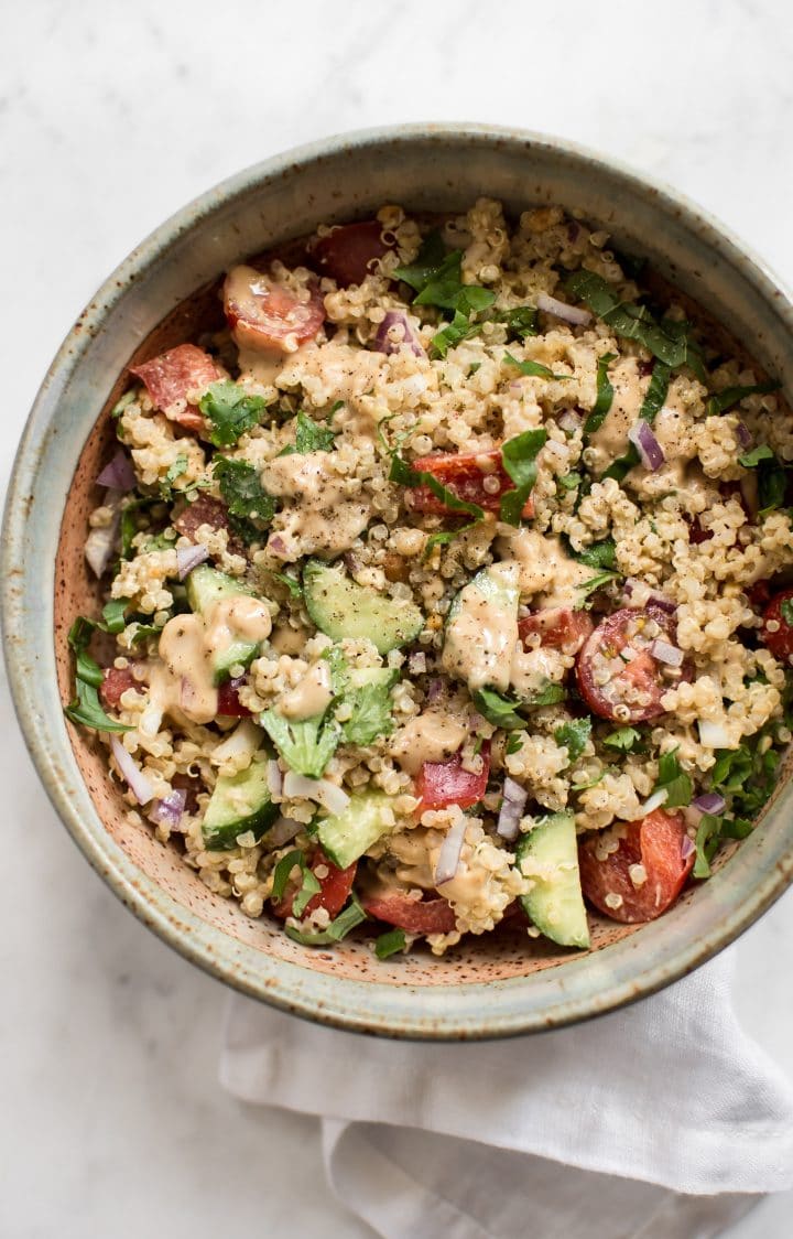 bowl with Thai quinoa salad drizzled with peanut lime dressing