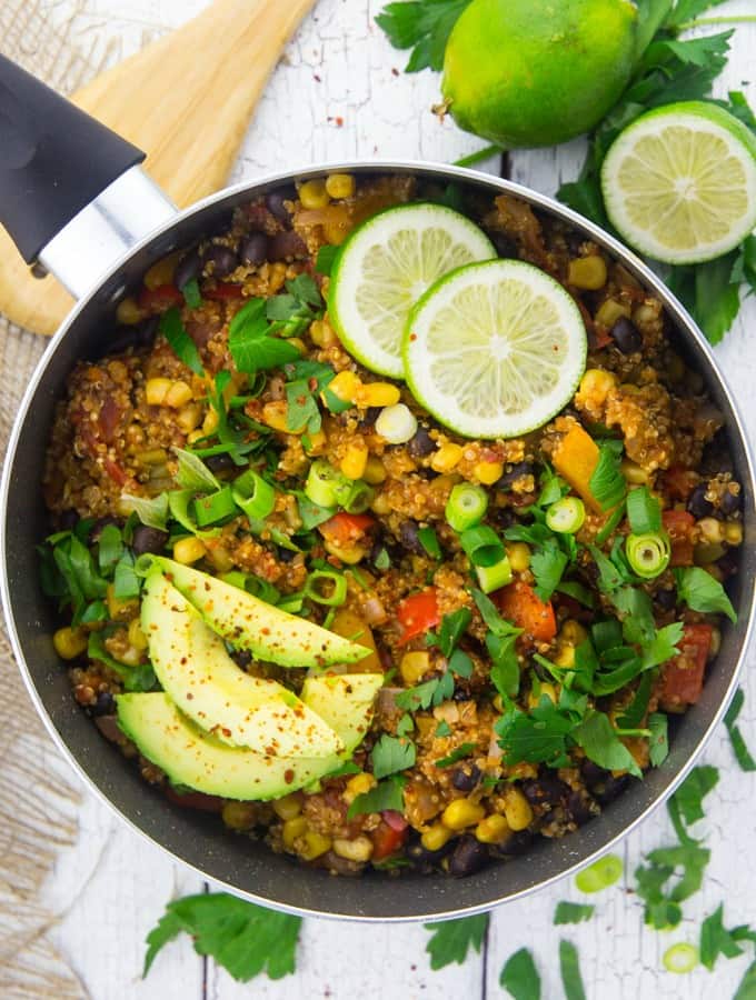pan of Mexican quinoa with avocado slices and lime