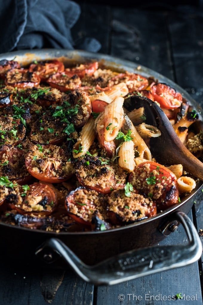 one pot vegan pasta in a skillet with a wooden serving spoon