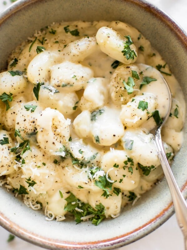 This one pan creamy Alfredo gnocchi recipe makes an awesome side dish or vegetarian main meal. It's easy to make, quick, and that parmesan garlic sauce is addictive!