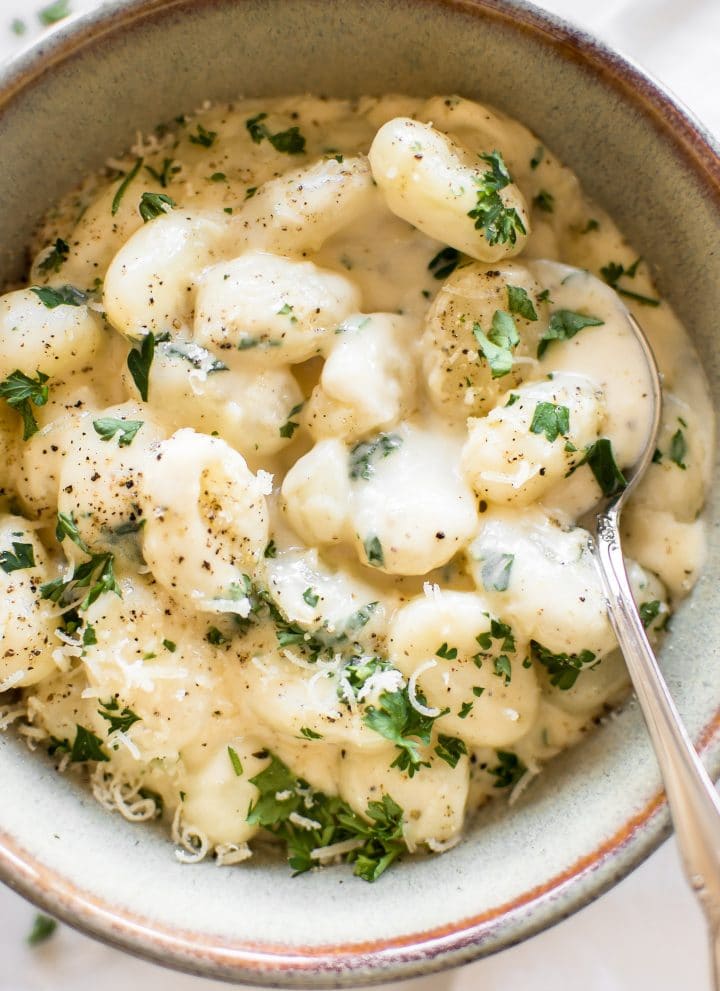 This one pan creamy Alfredo gnocchi recipe makes an awesome side dish or vegetarian main meal. It's easy to make, quick, and that parmesan garlic sauce is addictive!