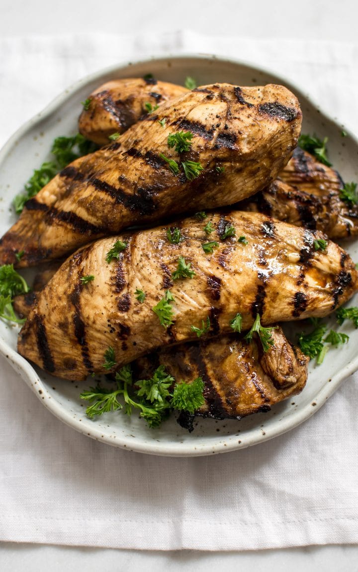 plate of grilled chicken breasts with balsamic marinade