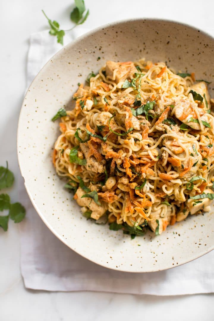 ramen chicken stir fry with carrots in a beige bowl