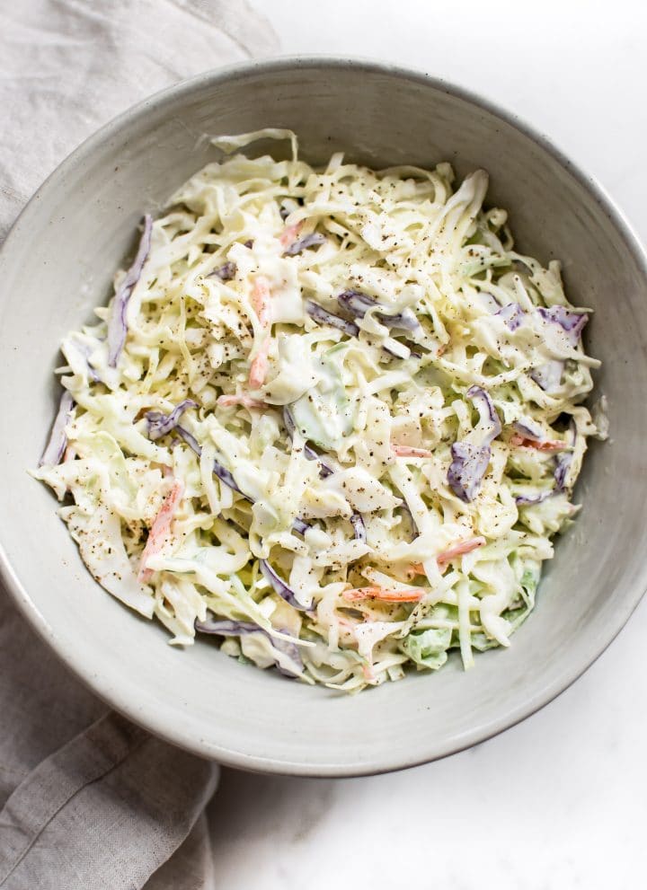 This simple coleslaw recipe has a delicious creamy homemade dressing that's perfectly tangy and sweet. The best classic coleslaw that is perfect for pulled pork, picnics, or BBQs. 