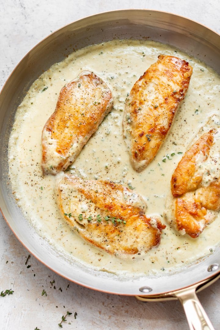 easy creamy herb chicken in a copper skillet