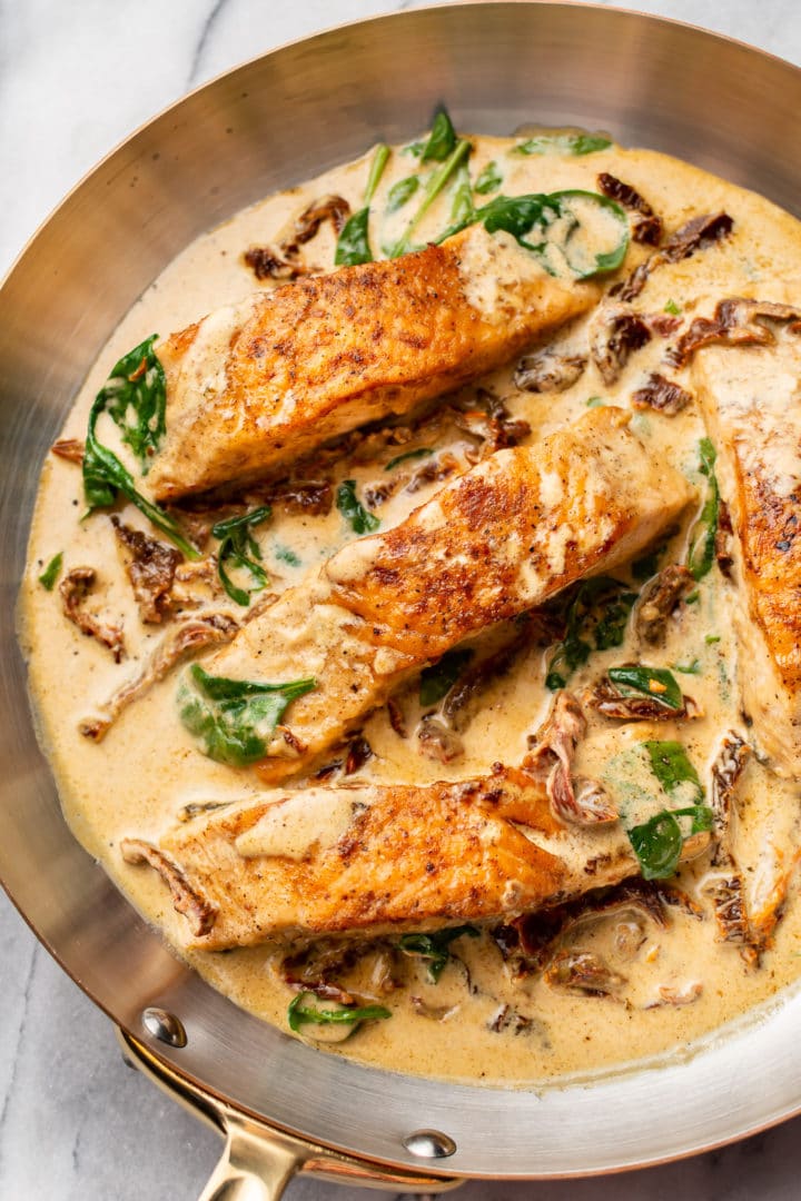 close-up of creamy Tuscan salmon in a skillet