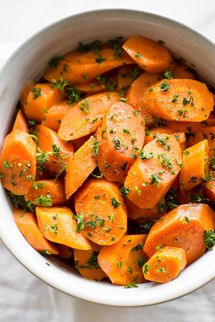 bowl with Instant Pot honey butter steamed carrots and parsley garnish