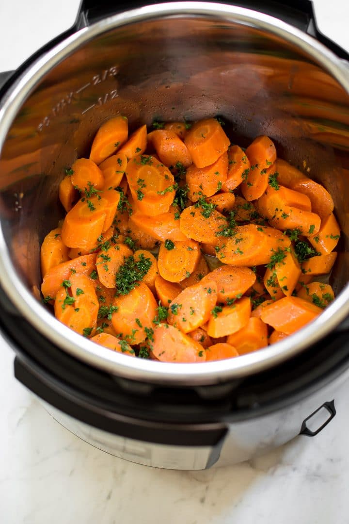 These honey butter steamed Instant Pot carrots are quick and healthy. The perfect easy electric pressure cooker side dish. Great for weeknight family meals or special occasions like Thanksgiving or Christmas dinner.