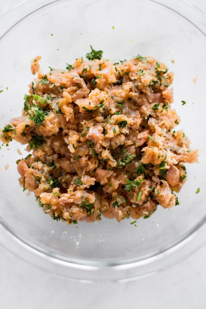 salmon patty ingredients in a glass mixing bowl