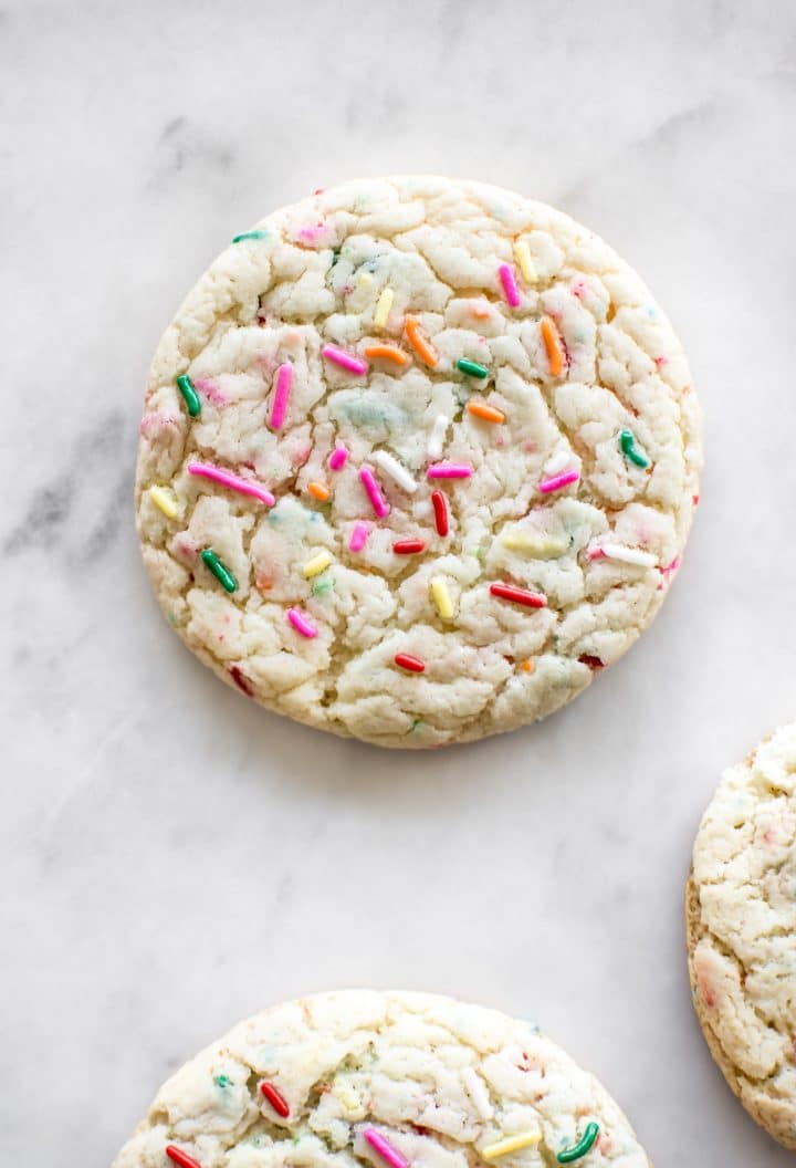 close-up of cookie with funfetti sprinkles on a marble surface