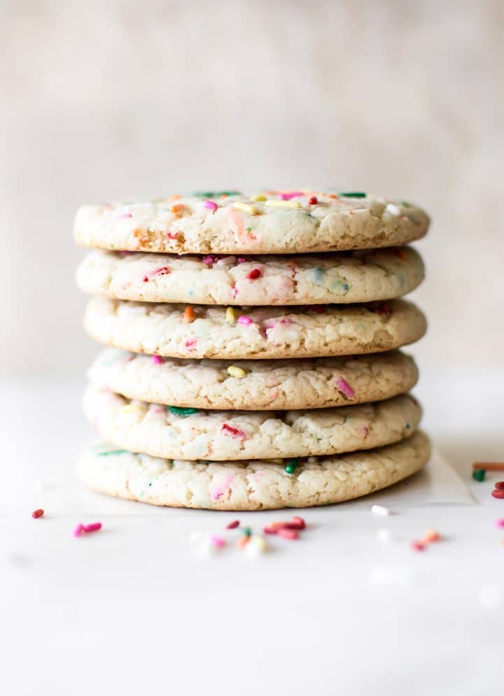 a stack of six soft funfetti cookies with sprinkles