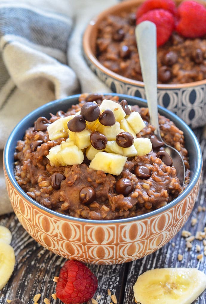 chocolate instant pot steel cut oats in a bowl with chocolate chips and a spoon