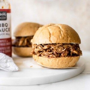It's so easy to make shredded BBQ chicken in the Instant Pot, and it only takes 30 minutes in total. You will love this simple electric pressure cooker pulled chicken recipe. The sandwiches are amazing!