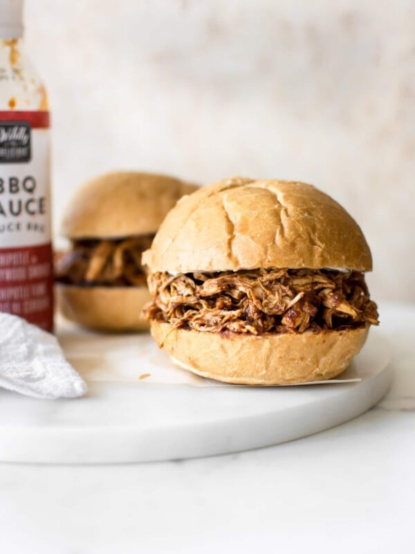 It's so easy to make shredded BBQ chicken in the Instant Pot, and it only takes 30 minutes in total. You will love this simple electric pressure cooker pulled chicken recipe. The sandwiches are amazing!