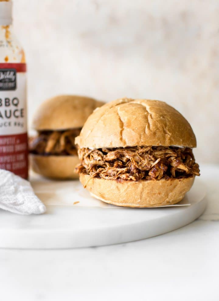 It's so easy to make shredded BBQ chicken in the Instant Pot, and it only takes 30 minutes in total. You will love this simple electric pressure cooker pulled chicken recipe. The sandwiches are amazing!