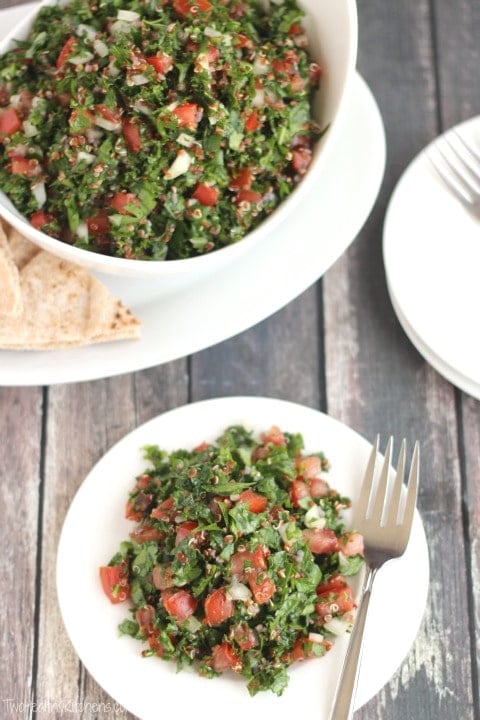 vegan tabouli salad in two bowl with a fork and pita bread