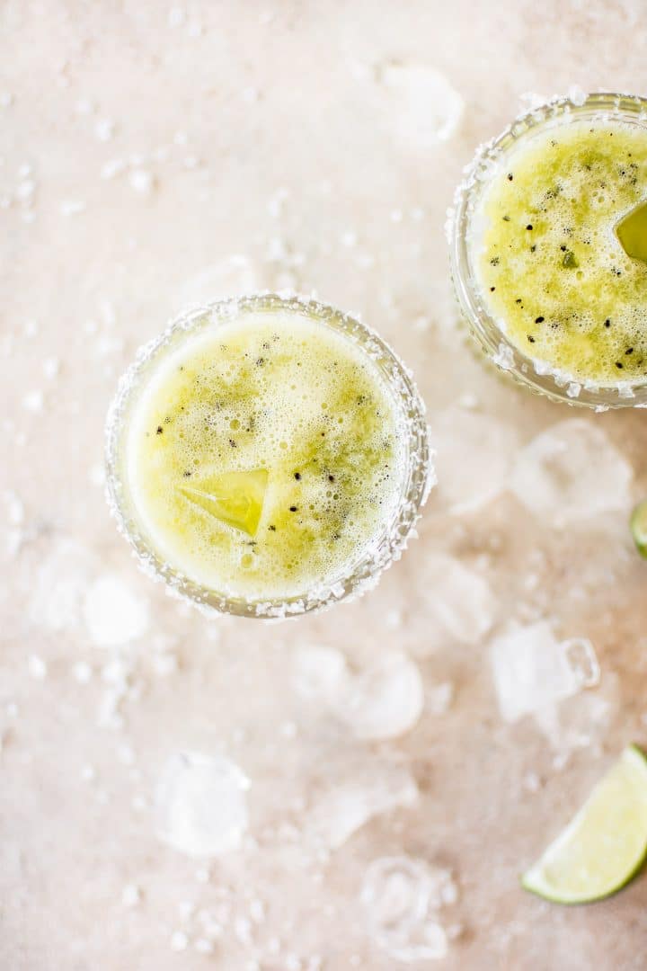 two glasses of kiwi margarita with ice