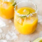 Homemade mango margaritas on the rocks are easy to make and refreshing in the summer! Dust off that tequila and try this simple fruity margarita today.
