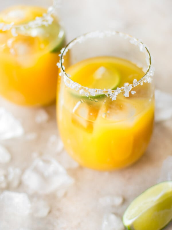 Homemade mango margaritas on the rocks are easy to make and refreshing in the summer! Dust off that tequila and try this simple fruity margarita today.