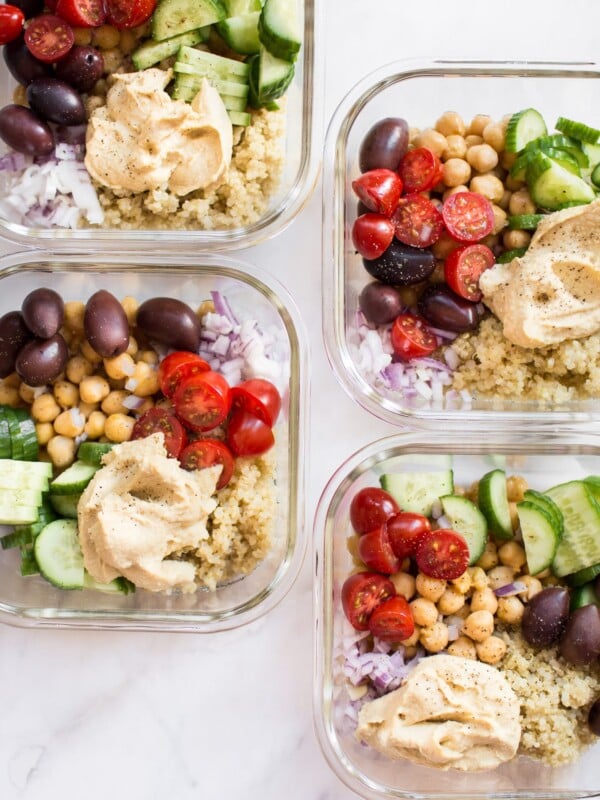 These simple, healthy, and delicious Mediterranean vegan meal prep bowls have quinoa, chickpeas, hummus, and an assortment of veggies. Easily prepare meals for the week with this recipe! Makes a tasty clean eating lunch or dinner.