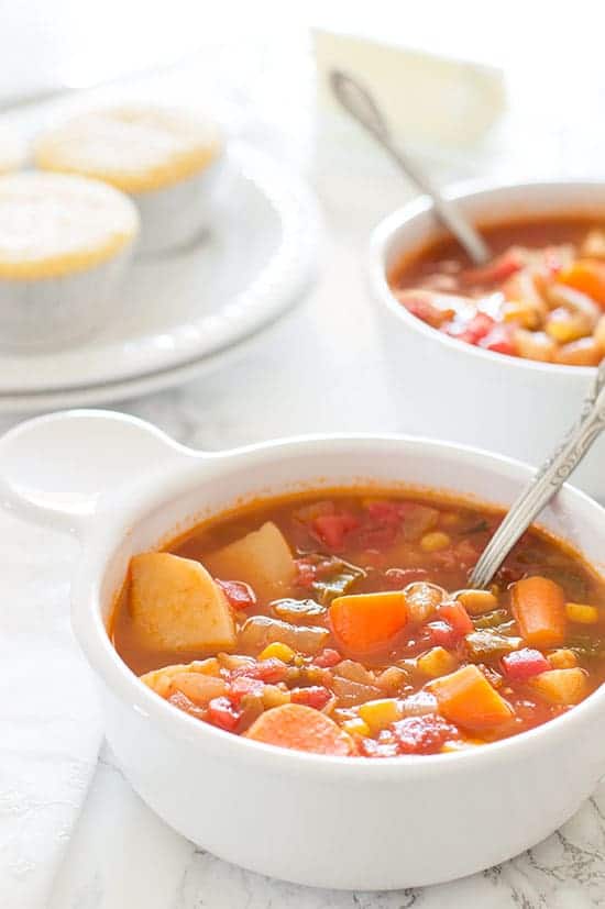 vegan mexican vegetable stew in a white dish with a spoon