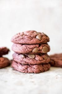 Soft, chewy, easy 3-ingredient (chocolate chips optional) red velvet cake mix cookies are quick and delicious. Perfect for Valentine's Day, Christmas, or any occasion. Duncan Hines boxed cake mix makes the best cookies!