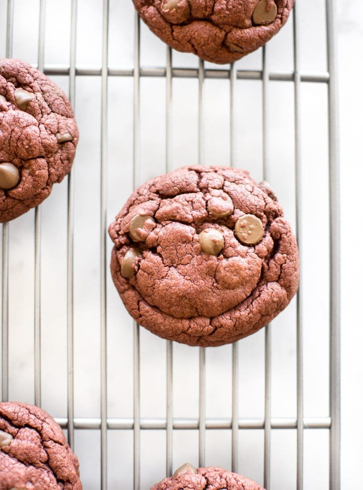 a red velvet cake cookie on a wire cooling rack