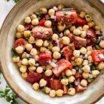 This easy vegan tomato chickpea salad recipe is healthy, delicious, and perfect for summer. You'll love the simple lemon vinaigrette. This cold chickpea salad is great for meal prep. 