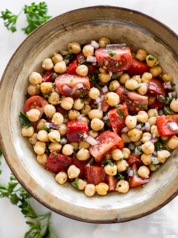 This easy vegan tomato chickpea salad recipe is healthy, delicious, and perfect for summer. You'll love the simple lemon vinaigrette. This cold chickpea salad is great for meal prep. 