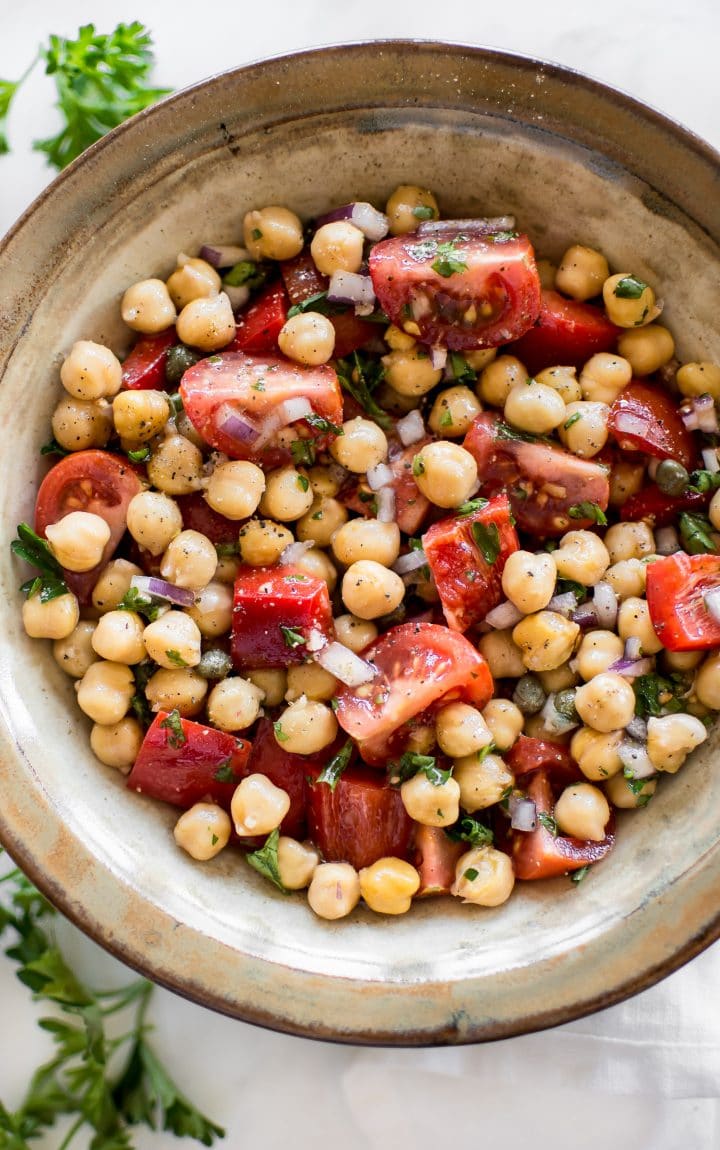 close-up of vegan chickpea salad in earthenware bowl