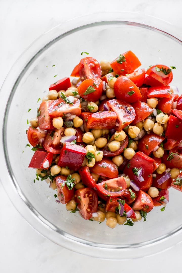 glass serving bowl with vegan tomato chickpea salad