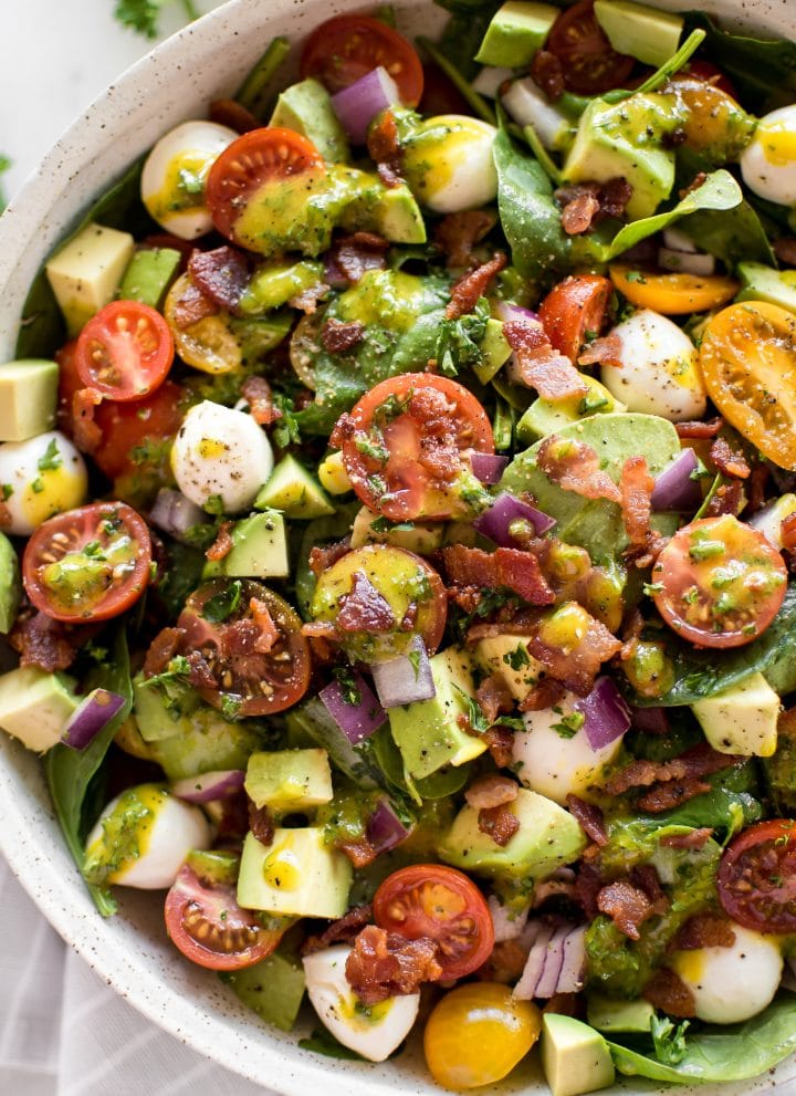 This easy avocado bacon salad with spinach, tomatoes, mozzarella, and a honey mustard vinaigrette dressing is perfect for healthy summer lunches. Quick and easy!