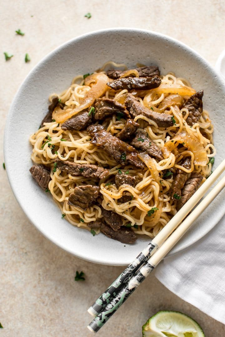 simple beef and ramen noodles on white plate with chopsticks 