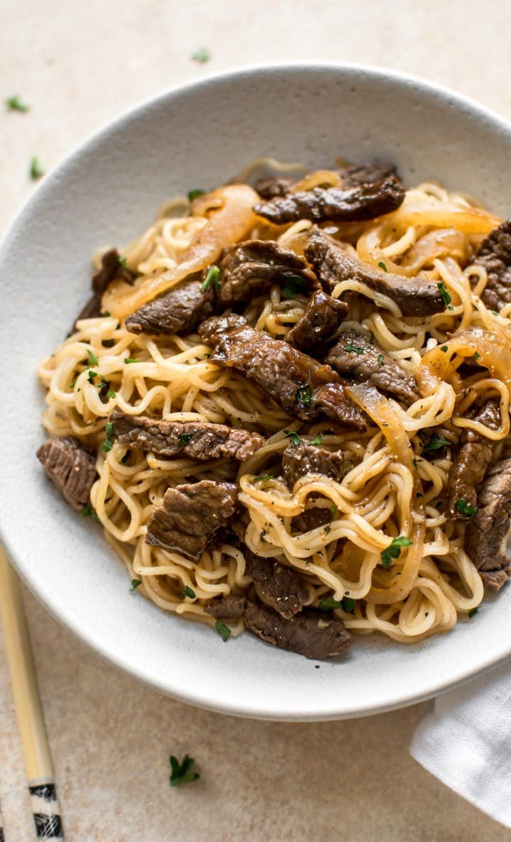 Asian beef and noodles on a white plate close-up