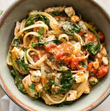 This chicken pasta with feta cheese, spinach, and tomatoes is healthy, easy to make, and delicious. A family favorite recipe for busy weeknight dinners.