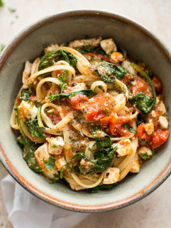 This chicken pasta with feta cheese, spinach, and tomatoes is healthy, easy to make, and delicious. A family favorite recipe for busy weeknight dinners.