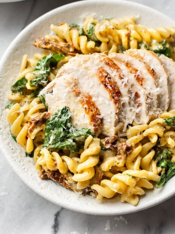 chicken pesto pasta in a white bowl