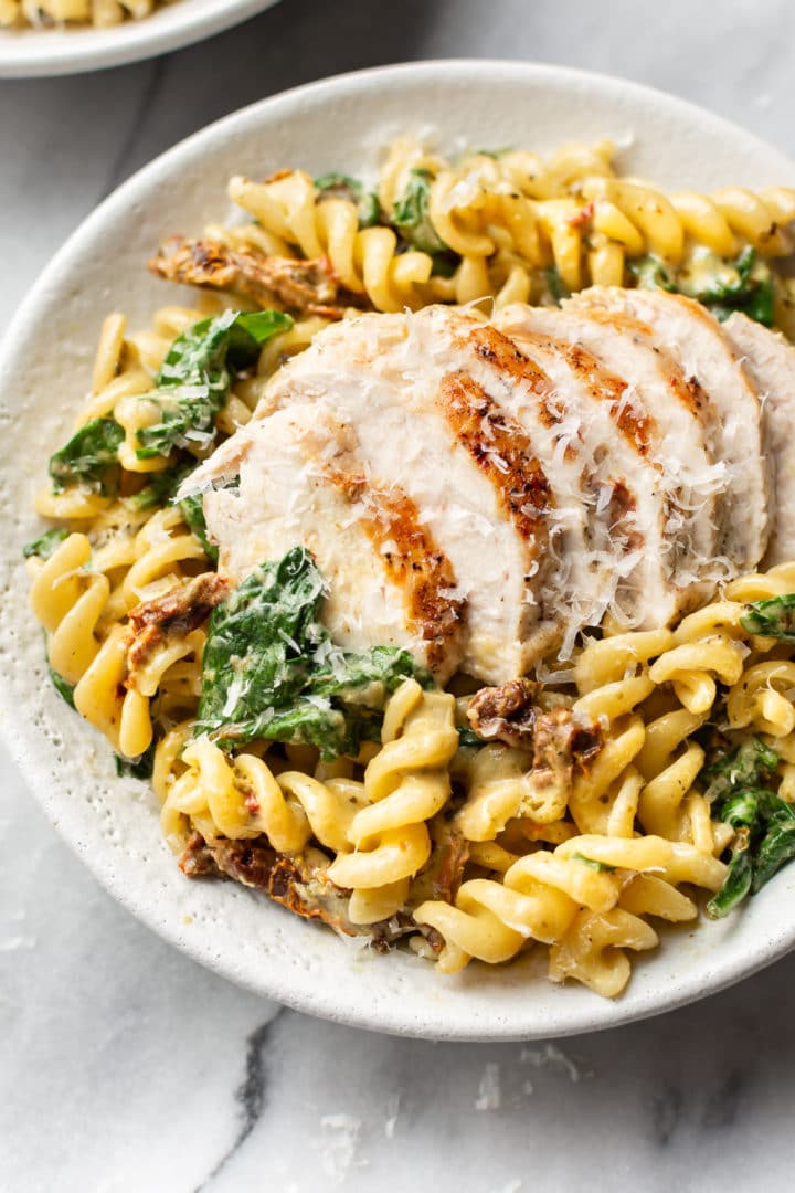 chicken pesto pasta in a white bowl