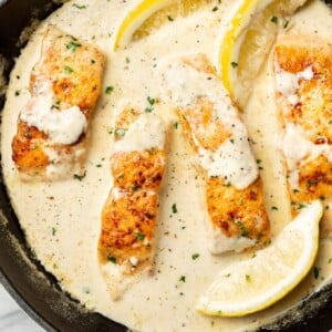 a skillet with creamy lemon salmon