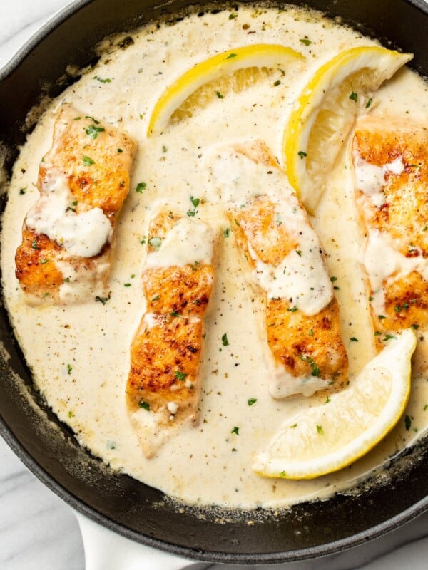 a skillet with creamy lemon salmon