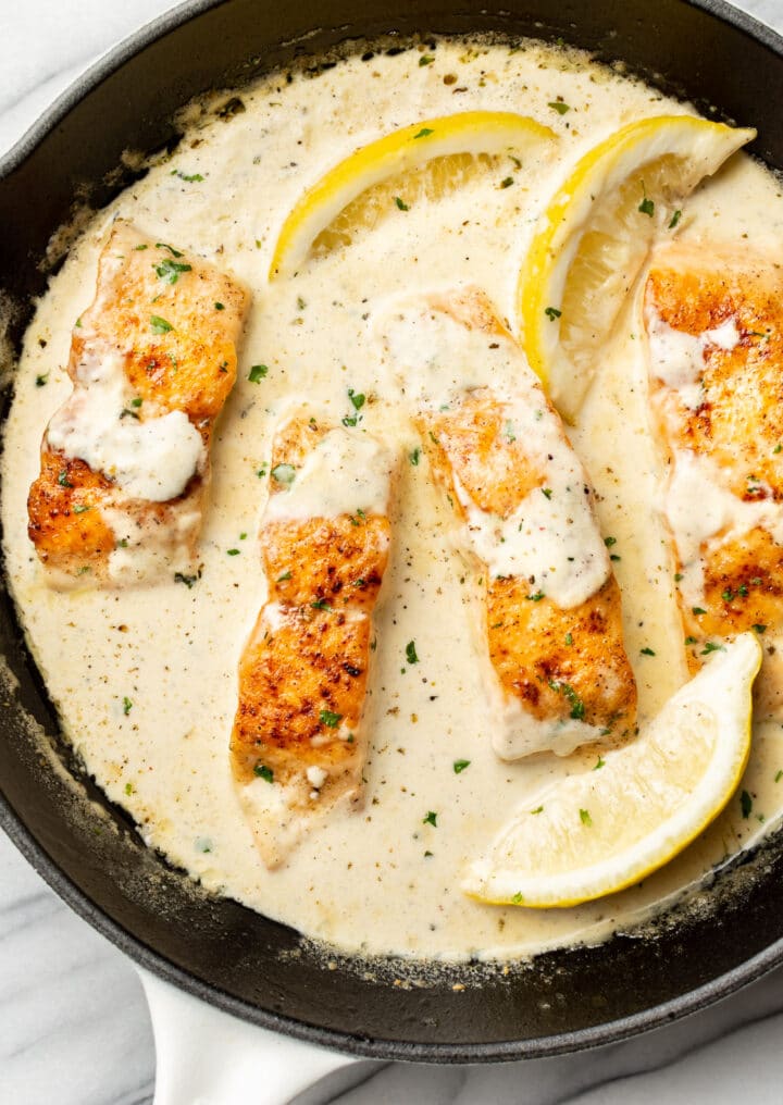 a skillet with creamy lemon salmon