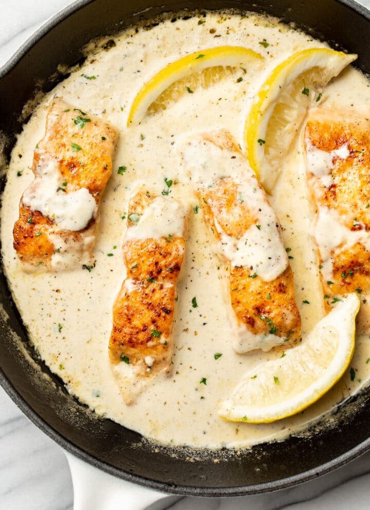 a skillet with creamy lemon salmon