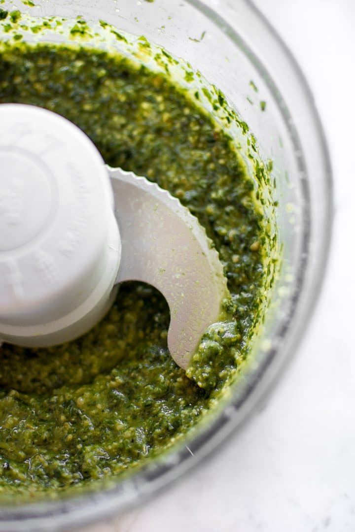 close-up of homemade pesto in a food processor