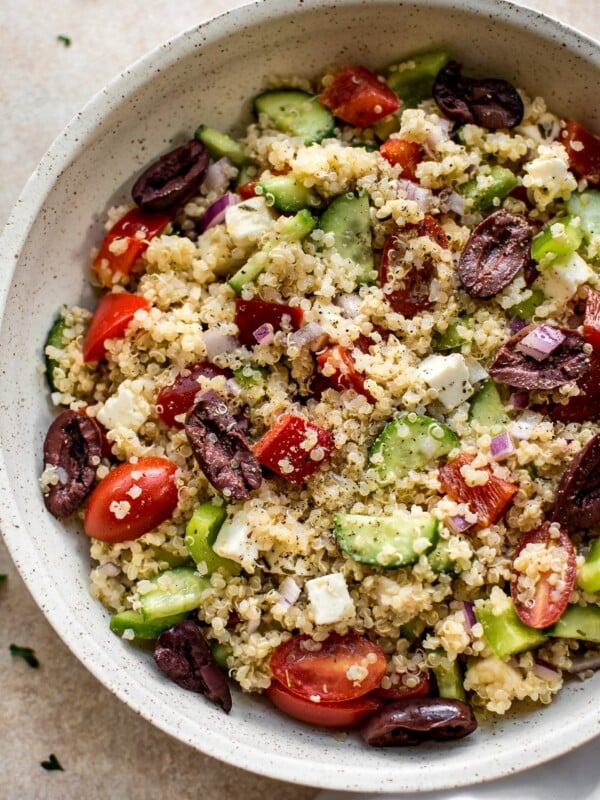 This healthy Greek quinoa salad is simple, easy to make, and delicious! The lemony vinaigrette dressing is light and flavorful. You can easily make the salad vegan by taking out the feta cheese.