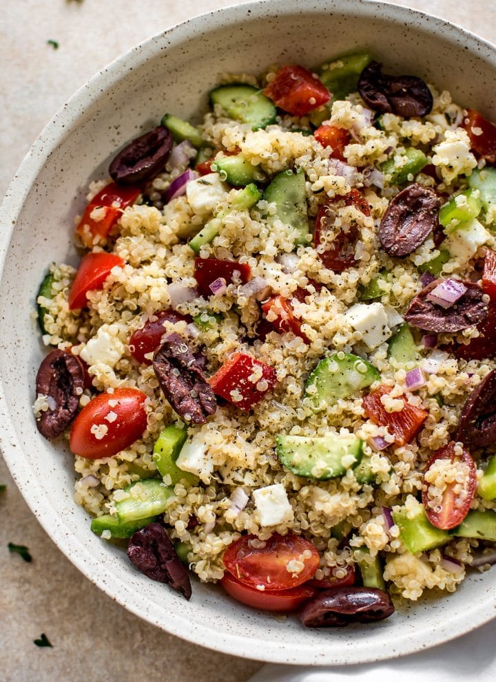 This healthy Greek quinoa salad is simple, easy to make, and delicious! The lemony vinaigrette dressing is light and flavorful. You can easily make the salad vegan by taking out the feta cheese.
