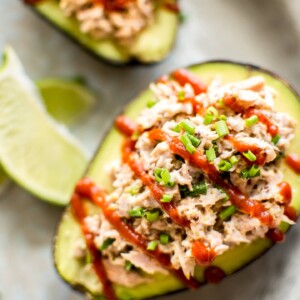 This spicy tuna stuffed avocado is healthy, fast, and delicious. This low-carb keto recipe is ready in only 10 minutes! It's super flavorful with sriracha, lime, mayo, mustard, and chives! An easy lunch idea. 