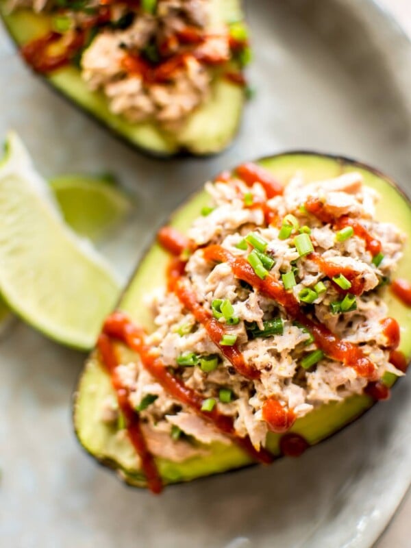 This spicy tuna stuffed avocado is healthy, fast, and delicious. This low-carb keto recipe is ready in only 10 minutes! It's super flavorful with sriracha, lime, mayo, mustard, and chives! An easy lunch idea. 